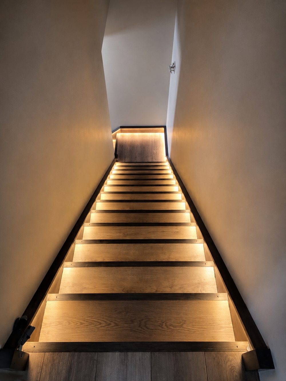 Interior staircase with wood treads and integrated LED step lighting